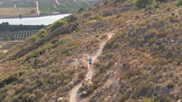 Man Running Up Mediterranean Desert Hiking Walking Trail Near Algorfa, Spain.