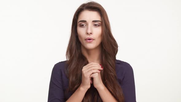 Nervous Beautiful Caucasian Female with Long Brown Hair Wearing Dark Blue Shirt Standing Kicking Her