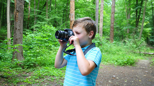 Boy In Wilderness Area Taking Picture