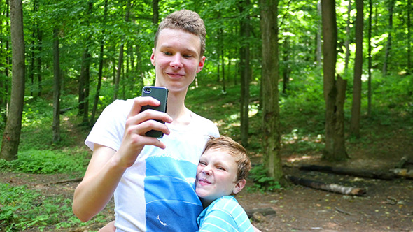 Young Brothers Taking Selfie With A Smartphone