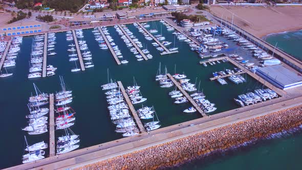 Aerial filming in 4K, performing lateral traveling from right to left of the port with the backgroun