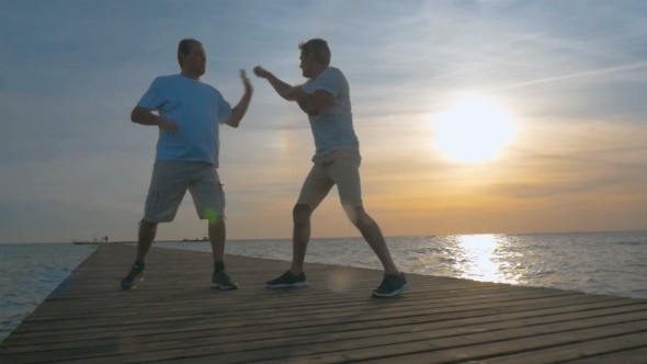Two Man Having Boxing Training On The Pier