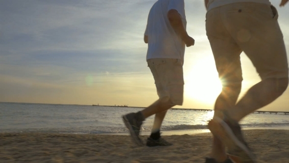 Two Men Jogging On The Beach