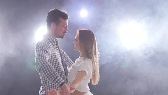 Concept of Social Dance and Relationships. Young Beautiful Couple Dancing Sensual Dance Bachata.