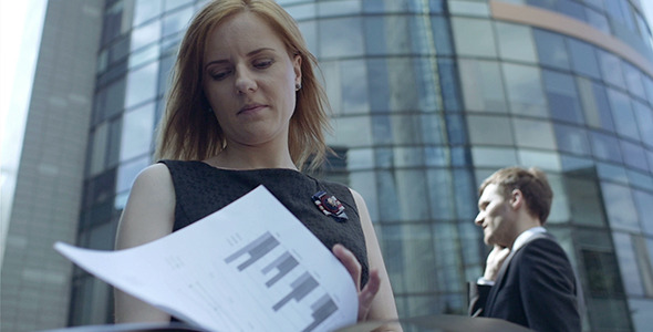 Business Woman And Documents In The Wind