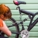 Young Girl Washing The Bicycle At Green Wall - VideoHive Item for Sale