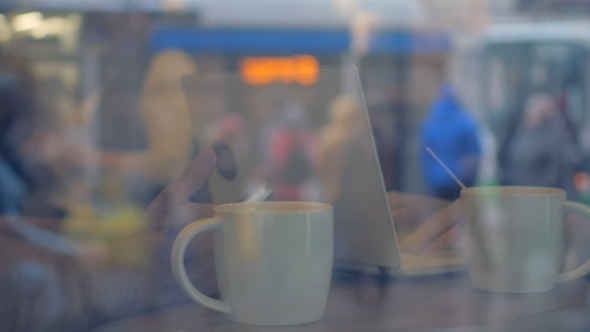 Using Cell Phone And Laptop During Tea Break In