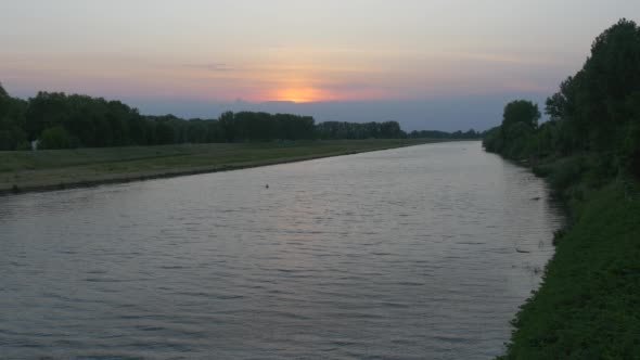 Orange, Yellow Sunset, River, Green Overgrown