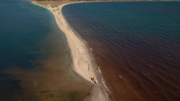 Aerial Top View Slow Motion Shot Walking Couple on Sand Beach Sand Bar Ukraine