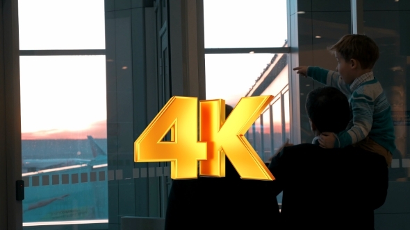 Parents With Son Looking At Planes alt