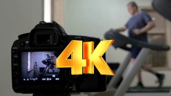 Camera Making Shots Of Man Running On Treadmill