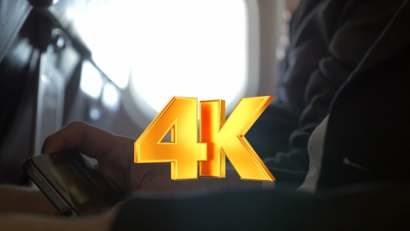 Man Watching Movie On Smart Phone In Plane