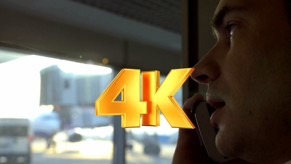 Man Having Phone Conversation At Airport alt