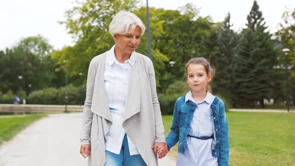 Grandmother and Granddaughter Walking at Park