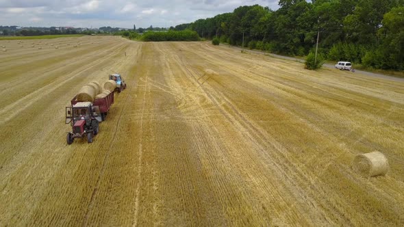 Tractor Loading Feed Straw Bales