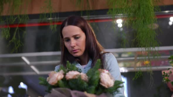 Panning Shot of Focused Woman Turning Bouquet Inserting Flowers