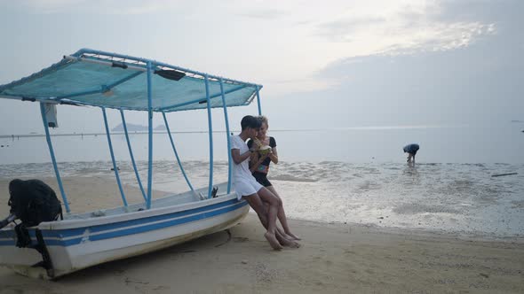 Mature Caucasian Woman Dating a Young Thai Man on the Beach