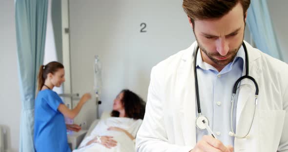 Portrait of smiling male doctor holding clipboard