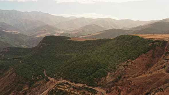 Aerial Drone Zoom in Tilt Up of Vast Mountains of Armenia