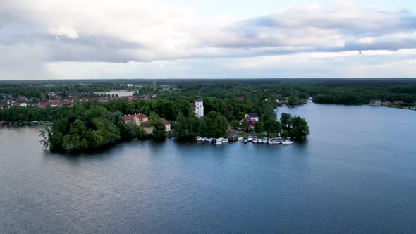 Aerial drone timelapse of Johanniterkirche church next to a beautiful lake.