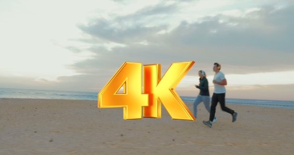 Young Couple In Headphones Running On The Beach alt