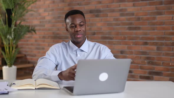 Pleasant Friendly Black Guy Manager or Financial Consultant Communicates with Colleagues on a Video