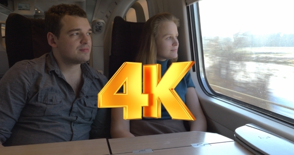 Two Passengers Looking Out The Train Window