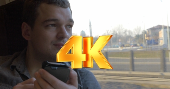 Man Chatting On The Mobile During Train Ride alt