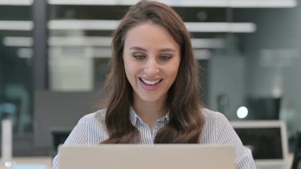 Portrait of Young Businesswoman Celebrating Success on Laptop