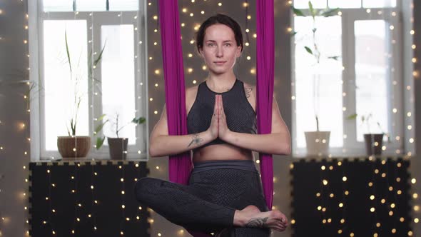 Young Woman Swinging in the Yoga Hammock