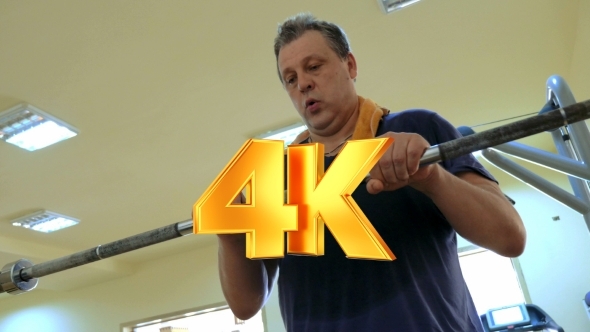 Man Exercising With Crossbar In The Gym