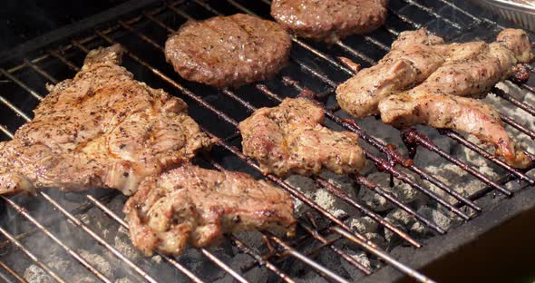 Tasty Hamburger Meat and Pork Grilling on Smoking Hot Barbecue