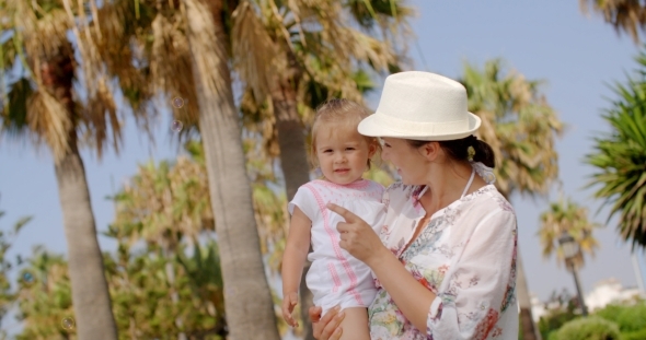 Mom Carrying Her Little Daughter At The Resort