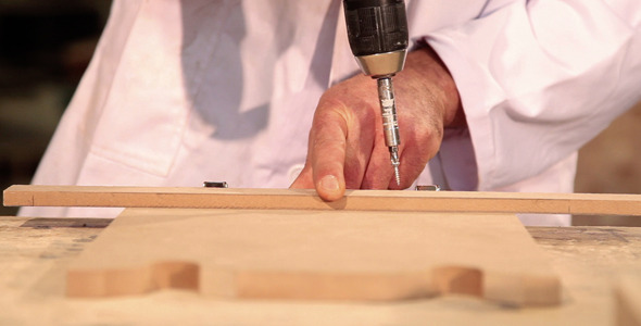 Carpenter Screwing Wood