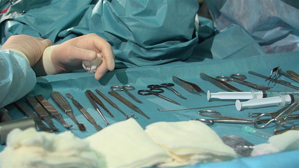 Hands Of A Surgical Nurse And Surgical Instruments
