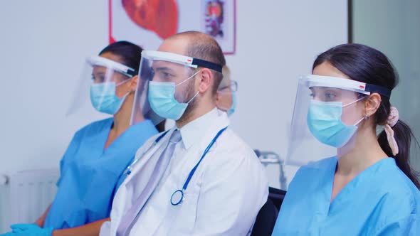 Medical Personnel with Face Mask in Hospital Waiting Area