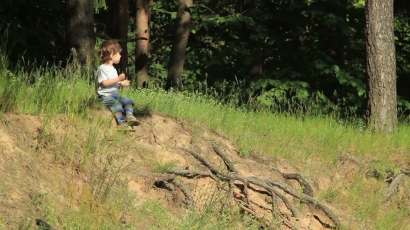 Boy Sits On a Cliff