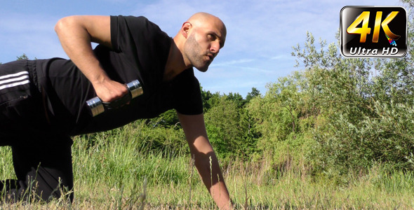 Man Training in Nature On Grass