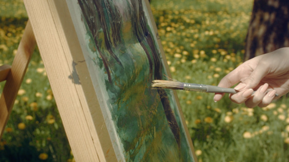 Woman Artist Paints In The Garden