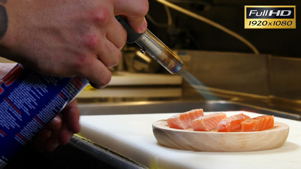 Sushi Chef Cooking Salmon with a Kitchen Torch