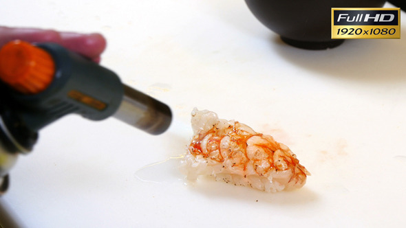 Sushi Chef Cooking Shrimp with a Kitchen Torch