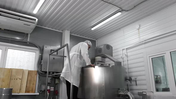 Technologist Checks Equipment at a Cheese Factory