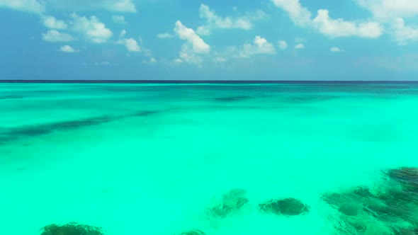 Aerial flying over sky of tranquil shore beach time by blue lagoon with bright sandy background of a