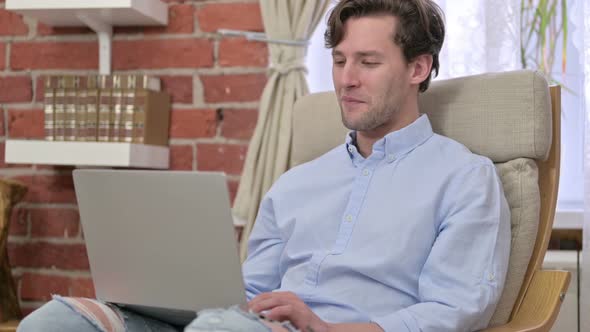 Young Man Doing Video Chat on Laptop