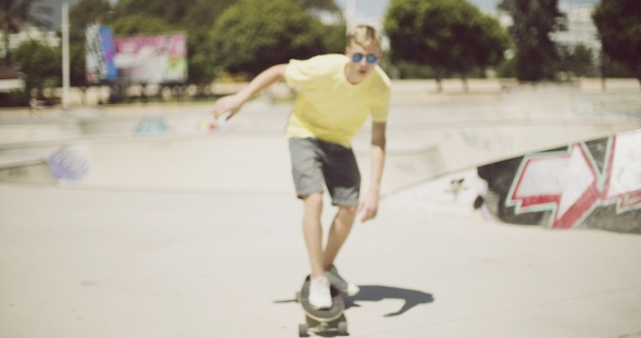 Young Man Enjoying a Summer Day Skateboarding
