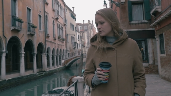 Woman With Coffee Walking In Venice