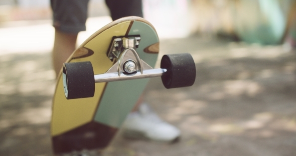 Man Tipping Up a Skateboard