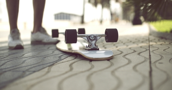 Longboard In Upside Down On a Concrete Ground