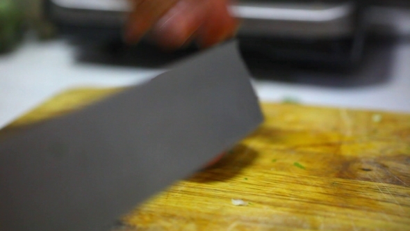 Female Hands With Knife, Cutting Fresh Red Tomato.