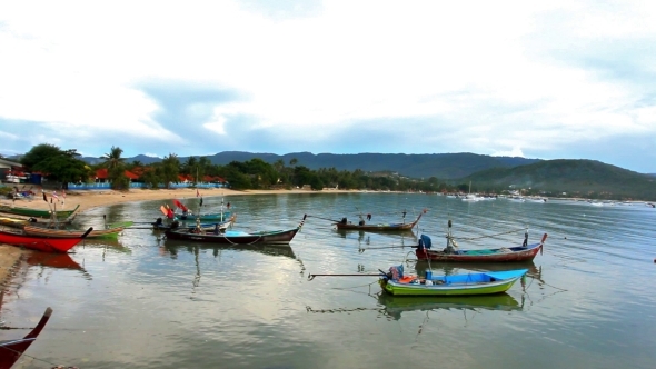 Fishing Boats Bobbing In The Sea At Sunset. 